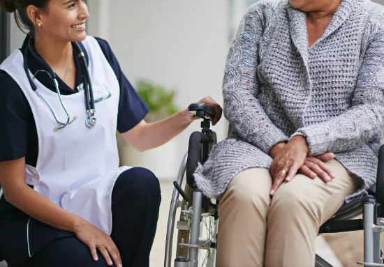 Nurse assisting a senior in a wheelchair